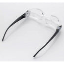 The 2.1X Diopter 3 Foldable 300 Degrees MaxTV Binocular TV Screen features a flexible hinge and provides hands-free 2.1X magnification for close-up tasks with transparent lenses and black arms, positioned upside down on a white surface.