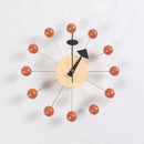 The Clock, background wall, wall clock features a beige circular face with minimalist black hands. Its European style is enhanced by twelve spokes ending in red-orange balls for a starburst design, making it a standout piece in contemporary interiors.