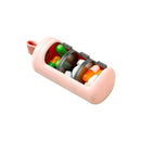 The Portable 3 Compartments Pill Storage Box is pink and cylindrical with a transparent section showing colorful pills inside. It includes a loop handle for convenient, stylish on-the-go use.