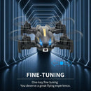 A black Rolling Light Camera Aircraft with blue lights zooms through a neon tunnel, starting an interactive play adventure. Text reads, Fine-Tuning: One-key fine tuning. You deserve a great flying experience. Blue arrows show its movement in this playful journey.
