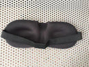 A Silicone Magnetic Anti Snore Nose Clip rests on a perforated white surface, doubling as a sleep mask. Its contoured eye areas ensure comfort while enhancing restful slumber compatibly with an anti-snore device.