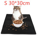 A cat sits on a black Cat Litter Pad Honeycomb Cat Pad Waterproof Urine Proof Pad next to a bowl of cat food with spilled kibble waterproof cat litter pad . Red text above reads S 30*30cm.