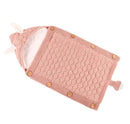 The Baby sleeping bag is a pink knitted design featuring a charming honeycomb pattern, wooden side buttons, and ear-like hood decorations. It offers cozy comfort with its soft white lining of either cotton wool or lamb cashmere.
