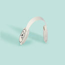 This product is embodied in white headphones with circular ear cups featuring a simple black design on a light blue background, offering a minimalist aesthetic with a sleek and modern look that includes the Child Safety Lock for enhanced peace of mind.