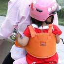 A child wearing a pink helmet and red dress is secured with a Child safety rope motorcycle child safety belt, riding on the back of an adult in a light pink shirt on a scooter.