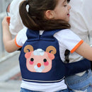 A young girl with brown hair in a ponytail wears a navy blue backpack featuring a cute cartoon sheep. She is securely carried by an adult in a white shirt, using the Child Safety Rope Motorcycle Child Safety Belt for a safe and stylish journey together.