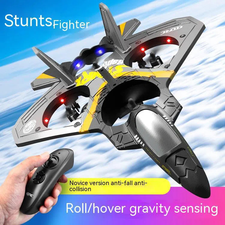 A V17 Fighter Drone, made from drop-resistant foam, performs stunts in the clouds. The product data mention anti-fall, anti-collision, and gravity sensing features to boost hand-eye coordination. In the image, a hand holds the remote control of this childrens remote control aircraft glider.