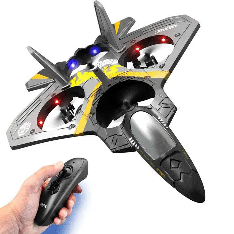 A futuristic black and yellow Childrens Remote Control Aircraft V17 Fighter Drone boasts LED lights. A hand grips the black remote, ready for flight. This exciting stunt toy, crafted from drop-resistant foam with fixed wings, is perfect for introducing kids to aerial exploration while enhancing hand-eye coordination.