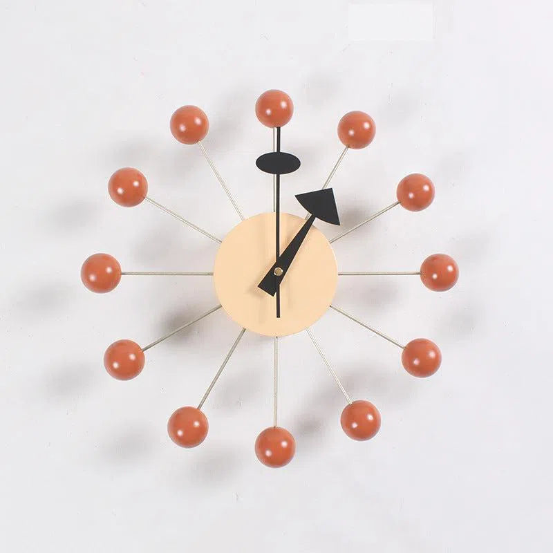 The Clock, background wall, wall clock features a beige circular face with minimalist black hands. Its European style is enhanced by twelve spokes ending in red-orange balls for a starburst design, making it a standout piece in contemporary interiors.