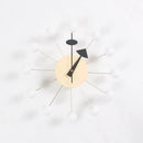 The Clock, background wall, wall clock features a minimalist beige circular face with twelve spokes ending in white bulbs, creating an atomic look and exuding European style. The black hour and minute hands add to its appeal for interior design enthusiasts.