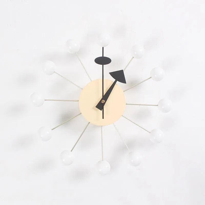 The Clock, background wall, wall clock features a minimalist beige circular face with twelve spokes ending in white bulbs, creating an atomic look and exuding European style. The black hour and minute hands add to its appeal for interior design enthusiasts.