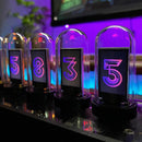 The Creative Led Electronic Digital Clock Solid Wood Nixie features four transparent domes displaying glowing digital numbers: 5, 8, 3, and 5. The clocks purple and blue illuminated background adds a futuristic atmosphere with a Nixie design-inspired touch.