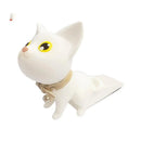 The Door Handle Punch-free Cat Door Stopper is a charming white feline with yellow eyes, sporting a beige collar and bell. Perched on a wedge-shaped base, it prevents door collisions while adding playful charm to any space.