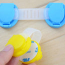 Two safety locks, in yellow and blue, feature a round clasp and flexible plastic strap with a non-toxic design. A hand opens the yellow lock to show adhesive pads, ideal for the Door Lock Safety Lock for Childrens Anti-Opening Door product.