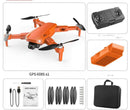 The GPS High-definition Dual Camera drone kit includes an orange drone for aerial photography, a remote controller, battery, screwdriver, USB cables, manual, propellers, screws, and a black carrying case.