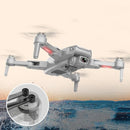 A drone with a GPS High-definition Dual Camera hovers elegantly over water, featuring extended legs and red lights against a pale sky. The inset shows its advanced landing gear, perfect for capturing stunning aerial views.