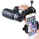 A person uses a High resolution binocular telescope equipped with a smartphone mount, facing forward. This setup offers impressive resolution and magnification, allowing the phone to display app icons while capturing stunning images through the binocular lens.