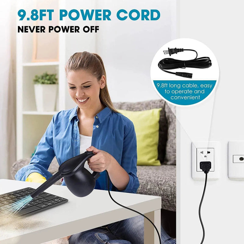 A woman in a blue shirt uses the Household Multi-function Computer Keyboard Dust Blower to clean a black keyboard, highlighting its versatility. Connected with a 9.8ft cord for continuous use, vibrant cushions and a plant add color to the setting.