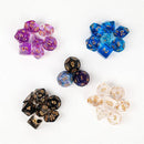 Four sets of Innovative Fantasy Starry Sky Resin Multi-sided Game Dice, in purple, blue, black, and clear with gold numbers, are arranged in a circle. Each set includes D20s and D6s to enhance your role-playing adventures with a fantasy touch.