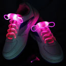 Against a dark backdrop, white sneakers are illuminated by glowing pink LED laces. Using fiber-optic technology, the Led Sport Shoe Laces Glow Shoe Strings Round Flash Light Shoelaces create a bright, eye-catching effect and give the shoes a futuristic look.