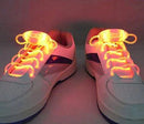 These white sneakers feature purple accents and bright orange LED sport shoe laces made with advanced fiber-optic technology, glowing vibrantly even in dim lighting.