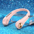 A pink Mini Neck Fan Portable Bladeless Hanging Neck Rechargeable Air Cooler with black vent holes and a gold button sits on a clear stand, against a sparkling blue backdrop, creating an eye-catching scene.