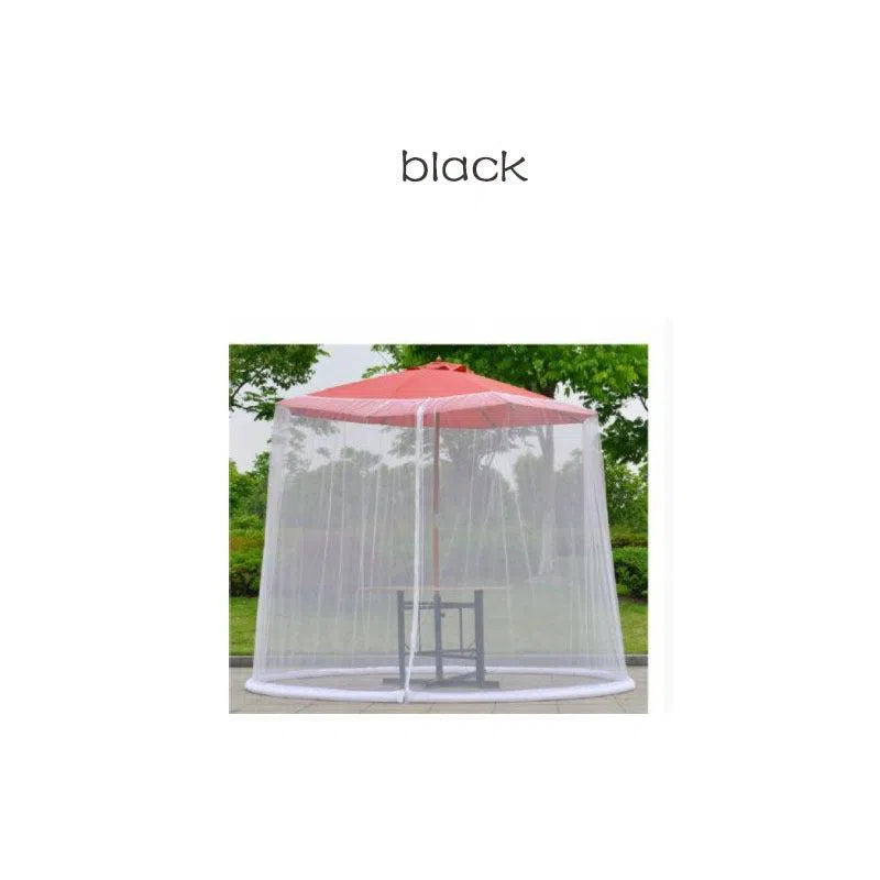 The Mosquito Net Outdoor Patio Umbrella Net Cover encloses an outdoor table and chairs beneath a vibrant red patio umbrella on the lawn, crafting an inviting space for relaxation.