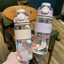 Two Portable Large Capacity Plastic Cups with pastel lids and ribbed grips, featuring adorable animal and sweet cartoon stickers. Temperature-resistant, theyre held by someone in a cozy pink sweater against a wooden table background.