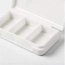 The Portable pill storage box is a sleek, white travel accessory made of durable plastic with three rectangular compartments for organized medication storage. Its compact design makes it ideal for those on the go.