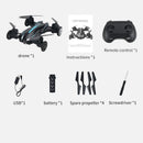 The Rolling Light Camera Aircraft Childrens Toys package is ideal for interactive play and includes a sleek black drone, remote control, user manual, USB charger, battery, four spare propellers, and a screwdriver—each marked with an asterisk to indicate quantity.