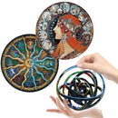 A hand holds a Rotating Puzzle Decompression 3D Educational Toy, enhancing fine motor skills. Above it are two round art pieces: one featuring an intricate illustration of a woman surrounded by zodiac signs, and another with a colorful abstract swirling design.