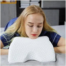 A person with blonde hair and eyes closed lies face down on a white pillow in a room filled with shelves and a desk, wearing a blue top. Nearby is a Silicone Magnetic Anti Snore Stop Snoring Nose Clip Sleep Tray Sleeping Aid Apnea Guard Night Device for relief from restless nights.