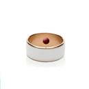A wide, smooth white smart ring with a gold interior showcases a high-tech design. A red ball appears to float centrally, blending elegance with innovation against a plain white backdrop.