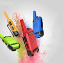 The TIENGU Professional Wireless Handheld Intercom Radios, available in green, red, blue, and yellow, appear to float against a light gray backdrop with a burst of multicolored powder. These vibrant walkie-talkies ensure you stay connected with style.