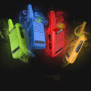 Four TIENGU Professional Wireless Handheld Intercom Radios—green, blue, red, and yellow—float against a black background. Each colorful device features an LED flashlight and visible buttons with a smoky, matching color trail following each radio.