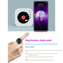 A smartphone shows a song with an album cover of a female artist beside a retro vinyl player. Below, text highlights the Wearable Finger Ring Bluetooth 5.0 Remote Control Smart Wireless Controller for audio mode and selfies, with icons illustrating each action.